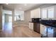 Bright kitchen with stainless steel appliances, black countertops, and wood-look floors at 2545 Divine Sky Dr, Henderson, NV 89044