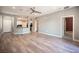 Spacious living room with wood-look flooring, a ceiling fan, and an open floor plan with kitchen access at 2545 Divine Sky Dr, Henderson, NV 89044