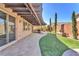 Inviting backyard with pavers, manicured grass, and a pergola that offers shade to the space at 261 Via Morelli, Henderson, NV 89011