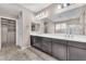 Bathroom featuring a double sink vanity, large mirror, and closet at 261 Via Morelli, Henderson, NV 89011