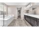 Bright bathroom featuring double vanity, soaking tub, and walk-in shower at 261 Via Morelli, Henderson, NV 89011