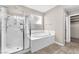 Bathroom with soaking tub and stand up shower with glass doors at 261 Via Morelli, Henderson, NV 89011
