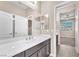 Bathroom with white countertops, dark cabinets, and views of a bedroom through the doorway at 261 Via Morelli, Henderson, NV 89011