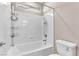 Bright bathroom featuring a shower-tub combo with white tiling and a toilet at 261 Via Morelli, Henderson, NV 89011