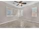 Bright, neutral bedroom featuring tile floors, multiple windows, and a ceiling fan at 261 Via Morelli, Henderson, NV 89011