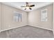 Well-lit bedroom with carpeted floors and two windows bringing in ample natural light at 261 Via Morelli, Henderson, NV 89011