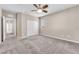 Neutral bedroom featuring carpeted floors, a ceiling fan, and natural light from the window at 261 Via Morelli, Henderson, NV 89011