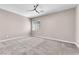 Spacious bedroom with neutral walls, plush carpeting, and a modern ceiling fan at 261 Via Morelli, Henderson, NV 89011