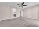 Cozy bedroom with carpet, neutral walls and view into the ensuite bathroom at 261 Via Morelli, Henderson, NV 89011