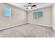 Neutral bedroom featuring plush gray carpet, modern ceiling fan and bright, natural light at 261 Via Morelli, Henderson, NV 89011