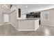 Open-concept kitchen with dark cabinets, mosaic backsplash, and stainless steel appliances at 261 Via Morelli, Henderson, NV 89011