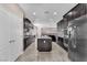 Stylish kitchen with dark wood cabinets, stainless steel appliances, and a granite-topped center island at 261 Via Morelli, Henderson, NV 89011