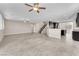 Bright and airy living room with tile flooring connecting to the kitchen and staircase at 261 Via Morelli, Henderson, NV 89011