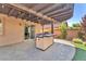 Covered outdoor kitchen with a built-in grill, perfect for enjoying meals outside at 261 Via Morelli, Henderson, NV 89011