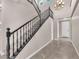 Elegant staircase with dark wood railings and plush carpet on the steps at 261 Via Morelli, Henderson, NV 89011