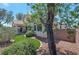 A lovely backyard with green turf and patio area for entertaining, surrounded by desert landscaping at 2640 Torch Ave, North Las Vegas, NV 89081