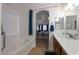 Bright bathroom with soaking tub and view of the primary bedroom at 2640 Torch Ave, North Las Vegas, NV 89081