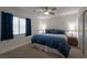 Bedroom featuring a ceiling fan, bedside lamps, and large window at 2640 Torch Ave, North Las Vegas, NV 89081