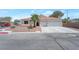 Charming single-story home featuring a three-car garage, desert landscaping, and a tile roof at 2640 Torch Ave, North Las Vegas, NV 89081