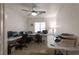 Functional home office space featuring desks, computer setups, ceiling fan, and a window for great natural light at 2640 Torch Ave, North Las Vegas, NV 89081