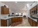Open-concept kitchen showcasing stainless steel appliances, ample countertop space, and seamless flow to the dining area at 2640 Torch Ave, North Las Vegas, NV 89081