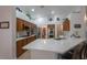Well-equipped kitchen showcases wooden cabinets, stainless steel appliances, and breakfast bar with seating at 2640 Torch Ave, North Las Vegas, NV 89081
