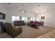 Spacious living room with plush seating, carpeted floors, and abundant natural light at 2640 Torch Ave, North Las Vegas, NV 89081