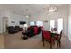 Open-concept living and dining area with modern lighting fixtures, comfortable seating, and a cozy atmosphere at 2640 Torch Ave, North Las Vegas, NV 89081
