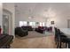 Spacious living room featuring high ceilings, large windows, and an open floor plan with tile and carpet at 2640 Torch Ave, North Las Vegas, NV 89081