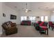 Spacious living room features high ceilings, ceiling fan, multiple seating options, and neutral carpet at 2640 Torch Ave, North Las Vegas, NV 89081