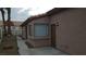 Single-Gathering home side view with a gravel yard and access to the back yard through an iron gate at 2777 Beaconfalls Way, Las Vegas, NV 89142