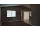 Carpeted living room featuring sliding glass door access to the backyard at 2777 Beaconfalls Way, Las Vegas, NV 89142