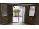 Patio with desert landscaping visible through sliding glass door and windows at 2777 Beaconfalls Way, Las Vegas, NV 89142