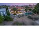 Aerial view of home's backyard featuring pool, waterfall, expansive terraces, and lush landscaping at 2793 Red Arrow Dr, Las Vegas, NV 89135