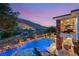 Elevated view of the backyard pool with a volleyball net, waterfall, and covered outdoor living space at 2793 Red Arrow Dr, Las Vegas, NV 89135