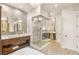 Beautiful bathroom with stone floors, a double vanity, a large walk-in shower, and a soaking tub at 2793 Red Arrow Dr, Las Vegas, NV 89135