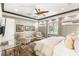Cozy bedroom with neutral tones, picture frame molding, and a dedicated desk and sitting area at 2793 Red Arrow Dr, Las Vegas, NV 89135