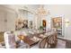 Elegant dining room with a large wooden table, chandelier lighting, and custom cabinets creates a luxurious dining experience at 2793 Red Arrow Dr, Las Vegas, NV 89135