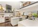 Bright, spacious kitchen with a Wolf range, custom hood and large island with white marble countertops and open shelving at 2793 Red Arrow Dr, Las Vegas, NV 89135