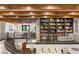 Upstairs library featuring dark built-in bookshelves with a rolling ladder and wrought iron railing overlooking the living room at 2793 Red Arrow Dr, Las Vegas, NV 89135