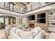 Inviting living room featuring a stone fireplace, built-in shelving, and views of the landscaped backyard through sliding glass doors at 2793 Red Arrow Dr, Las Vegas, NV 89135