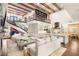 Spacious living room with soaring ceilings, wooden beams, grand staircase, and gourmet kitchen creates an inviting atmosphere at 2793 Red Arrow Dr, Las Vegas, NV 89135