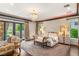 Luxurious main bedroom features a sliding door entry to the outside, a chandelier and a sitting area at 2793 Red Arrow Dr, Las Vegas, NV 89135