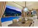 Covered outdoor dining area overlooking a scenic pool and mountain views at twilight at 2793 Red Arrow Dr, Las Vegas, NV 89135