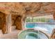 Custom pool and spa features a rock grotto with a waterfall, stone accents, and landscaping at 2793 Red Arrow Dr, Las Vegas, NV 89135