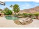 Backyard pool and tanning ledge with a water volleyball net and view of the desert mountains at 2793 Red Arrow Dr, Las Vegas, NV 89135