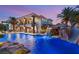 Backyard pool with rock features, a slide, spa, and lush tropical landscaping at 2793 Red Arrow Dr, Las Vegas, NV 89135
