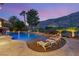 Resort-style pool with a volleyball net, waterfall and slide, lounge chairs and mountain views at 2793 Red Arrow Dr, Las Vegas, NV 89135