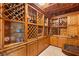 Custom, climate-controlled wine cellar featuring wood cabinetry and shelving for ample wine storage and glass displays at 2793 Red Arrow Dr, Las Vegas, NV 89135