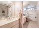 Bathroom with a double sink vanity, mirror and separate bath and shower at 2857 San Lago Ct, Las Vegas, NV 89121